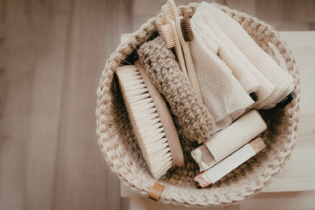 A woven basket containing various eco-friendly products such as soap bars, toothbrushes, and towels made from natural fibers.の写真素材