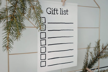 A white piece of paper with a list of blank checkboxes and lines, titled 'Gift list', hanging on a...