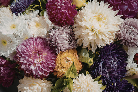 A vibrant bouquet of chrysanthemum flowers in various colors including pink, purple, white, and...