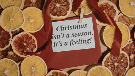 A visually appealing arrangement of dried orange and blood orange slices surrounding a red gift tag...