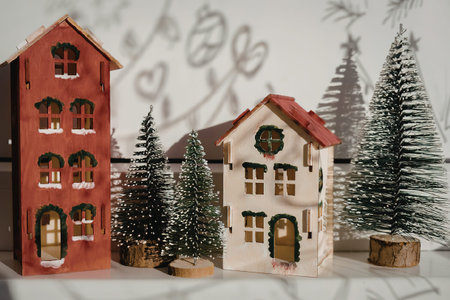 A miniature Christmas scene featuring two houses and several trees