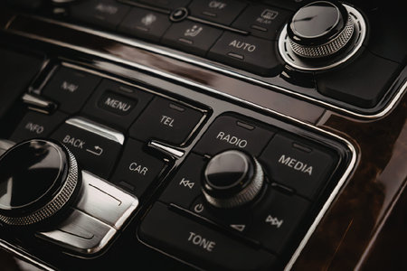 A close-up view of a car's audio control panel, showcasing various buttons and dials.の写真素材