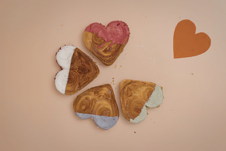 A group of heart shaped cookies with different colored icing on a table with a big red heart