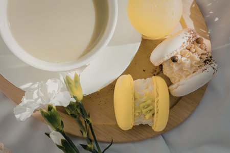 A cup of tea, a slice of cake, and a white flower