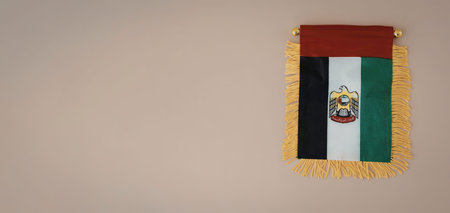 The image shows a flag with a red, white, green and black color scheme and a yellow fringe.