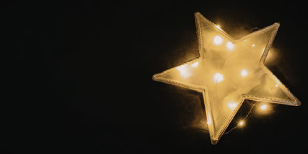 A bright yellow star with glowing lights on a black background