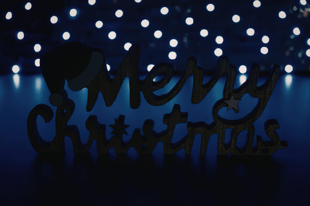 A decorative Merry Christmas sign with a festive light background