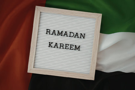 A letter board with 'RAMADAN KAREEM' message on the UAE flag background