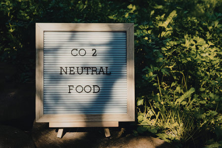 A sign in a natural setting promoting Co2 neutral food