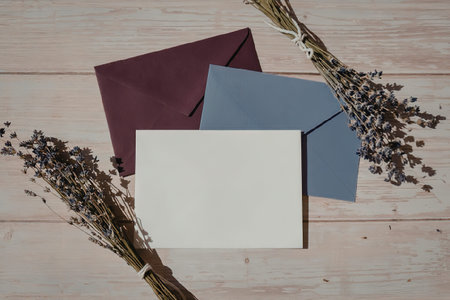 A collection of stationery items including envelopes and a card, accompanied by dried lavender...
