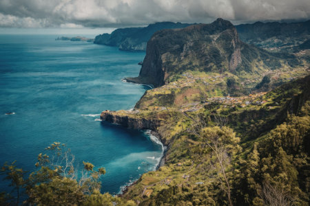 aerial view of a cliffside with a body of water and lush greenery