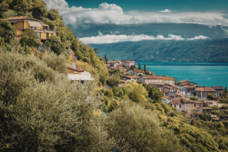 A picturesque coastal town nestled among lush greenery and overlooking a serene body of water