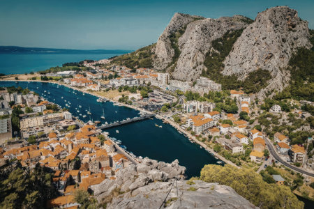An aerial view of a picturesque coastal town with a river flowing through it, surrounded by...