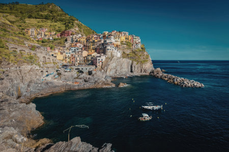 A picturesque cliffside with colorful houses overlooking a calm sea