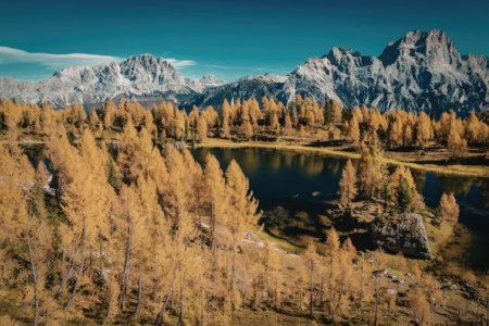 a serene mountain landscape with a lake surrounded by trees with yellow leaves