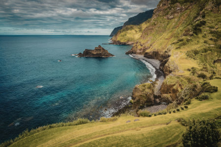 aerial view of a coastline with green hills and a blue ocean