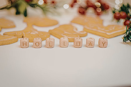 A festive arrangement of holiday cookies and decorations on a white table.