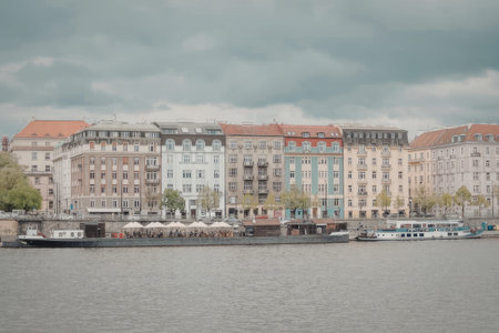 A row of colorful buildings along a river with boats docked in front of them.