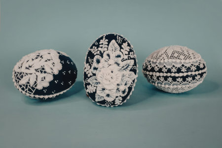 Three decorative ceramic objects with floral patterns on a blue backgroundの写真素材