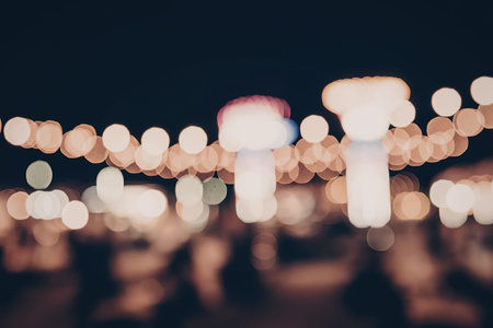 A blurry nighttime scene of city lights with a dark background
