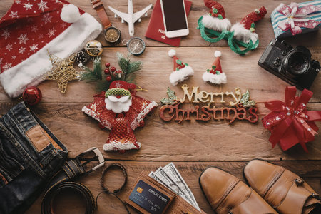 A collection of Christmas items on a wooden table, including decorations, clothing, and accessories.