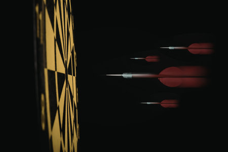 A close-up of darts on a dartboard, with a yellow and black sections visible on the left side, and...