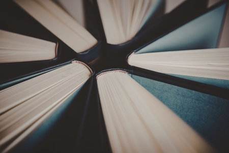 A photograph of open books with pages fanned out