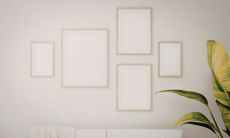 A minimalist interior design with empty picture frames on a white wall and a green plant