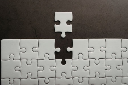 A puzzle with one piece missing and another piece on top, highlighting the uniqueness of the lone...