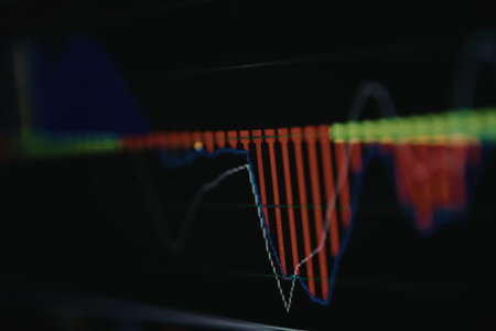 A blurry image of a stock market graph with red and green lines on a black background.