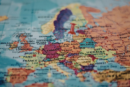 A colorful map of Europe with a red pin marking a specific location