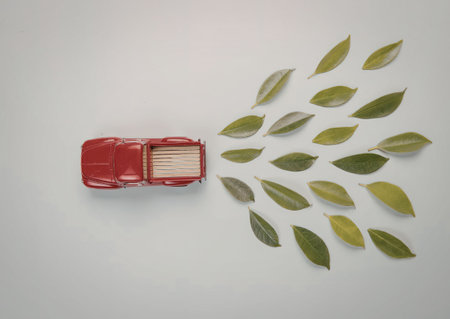 A red car with leaves coming out of it, symbolizing eco-friendly transportation and sustainability.