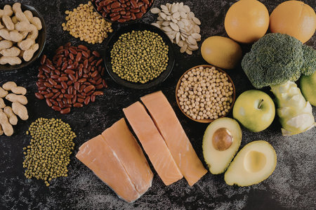 A selection of healthy food ingredients including fruits, vegetables, nuts, seeds, and fish,...