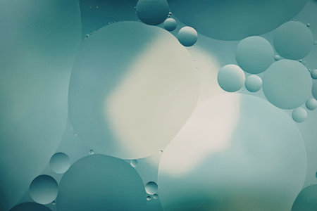 An image of teal liquid with various sized bubbles and a bright light spot.