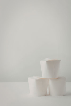 Three white paper rolls stacked on top of each other, with a plain white background