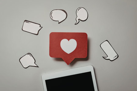 A graphic representation of social media notifications, featuring a red speech bubble with a heart,...