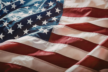 American flag waves gently with red and white stripes and white stars on a blue background...