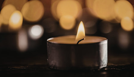 Candle flame burns softly in a peaceful ambiance surrounded by multiple candles in the background...