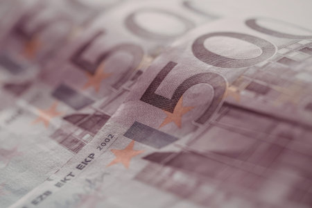 Fifty euro banknotes are arranged neatly, displaying a prominent purple hue with orange stars and detailed design elements symbolizing european currency and financial transactions.の写真素材