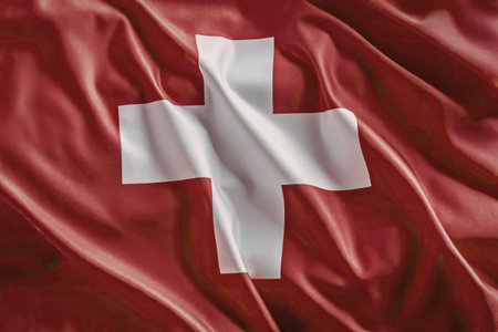 Switzerland national flag waves with red background and white cross symbolizing patriotism and...