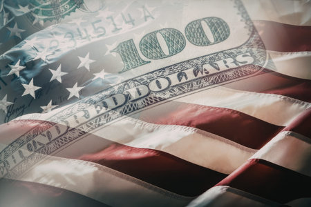 American flag waving with a superimposed hundred dollar bill representing finance and currency...