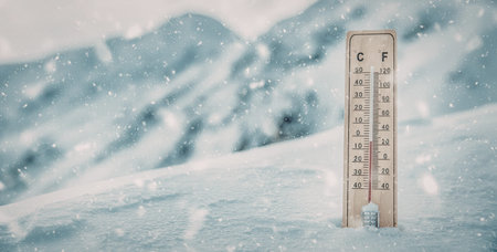 Wooden thermometer stands planted in deep snow recording subzero temperatures amidst a softly...
