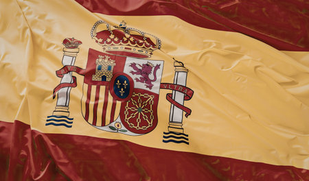 Spanish national flag waving with coat of arms displaying vibrant colors and symbolic emblems...