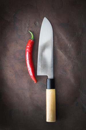 japanese Knife with Chili on old Leatherの写真素材