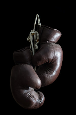 old Boxing Gloves, hanging, isolated on black Background