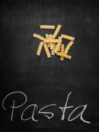 Fussili on old Chalkboard with Text "Pasta"の写真素材