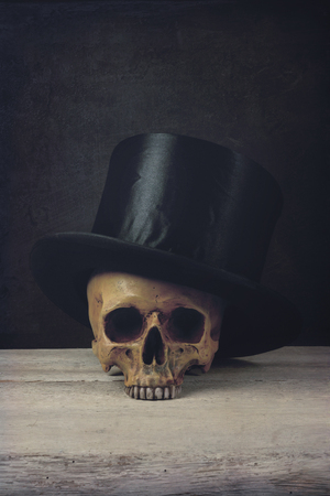 Vanitas with Skull and Topper Hat on woodの写真素材