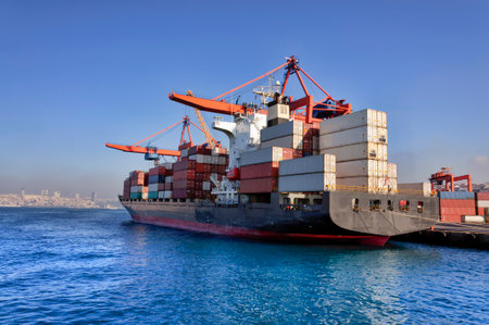 Container Cargo freight ship with working crane bridge for Logistic Import Export backgroundの写真素材