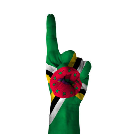 Hand pointing up direction, Dominica painted with flag as symbol of up direction, first and number one symbol - isolated on white backgroundの写真素材