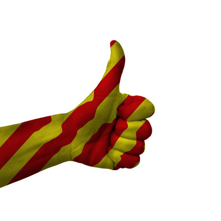 Hand making thumbs up sign, catalonia painted with flag as symbol of thumbs up, like, okay, positive  - isolated on white backgroundの写真素材